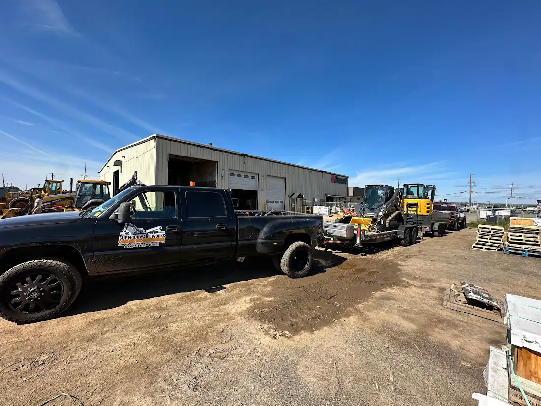 Superior Yard Works branded truck in front of the shop with the company's equipment