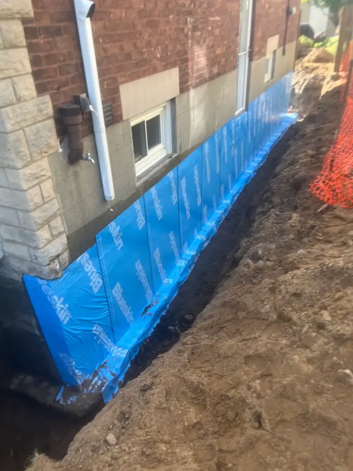 Waterproofed foundation with weeping tile